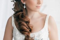 a delicate and chic side swept hairstyle with a twisted and dimension on top and waves down is a lovely and cool solution