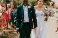a green pantsuit, a white shirt, black loafers, a spaghetti strap wedding dress with a lace bodice and silver shoes