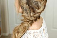 a lovely side swept braid into a ponytail, with a bump on top and waves down is a great idea for a boho or rustic bride