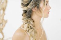 a messy side swept hairstyle with a messy volume on top and a braid on one side plus waves down is a chic and cool idea