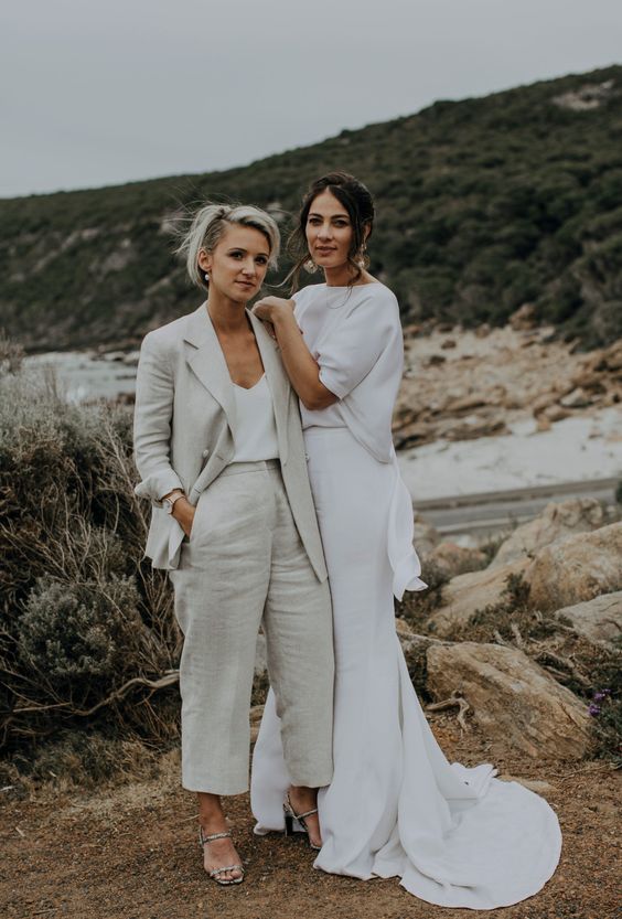 a neutral linen pantsuit, a white top and silver shoes, a white separate with a top with short sleeves and a skirt with a train