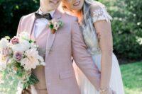 a pink three-piece pantsuit, a white shirt, a black bow tie and a boutonniere for a romantic bridal look