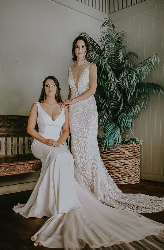a plain mermaid wedding dress with a plunging neckline and a long train plus a lace mermaid wedding dress with a plunging neckline and a train