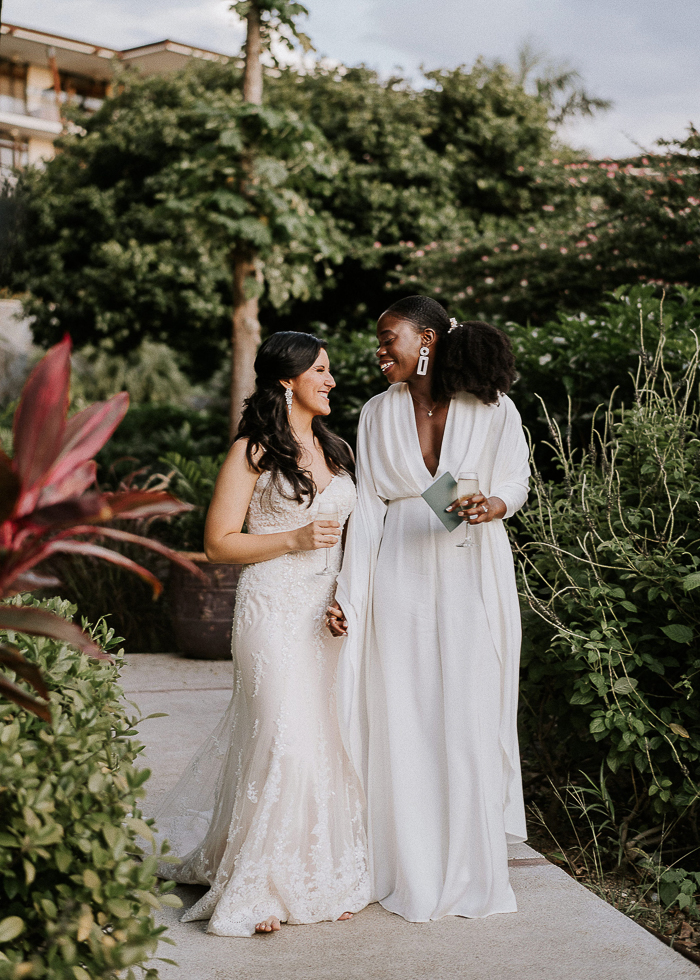 a plain white jumpsuit with a plunging neckline and wideleg pants, a boho lace mermaid wedding dress with a train