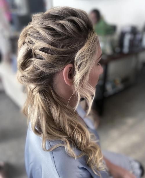 a pretty side ponytail with a braided top and a wavy ponytail and waves framing the face is amazing