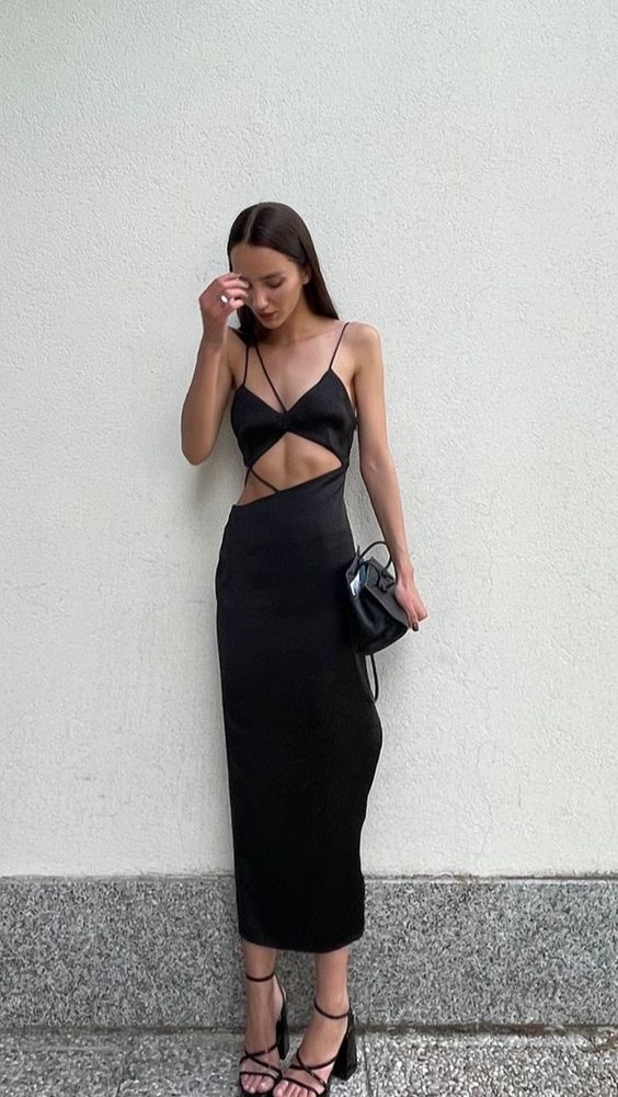a sexy black maxi dress with a strappy top and cutouts, black strappy shoes, a black bag are a cool idea for a bachelorette