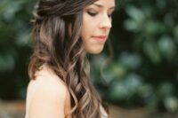 a subtle wavy half updo with a wavy top and waves on one side is a delicate solution for a garden bride