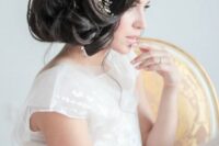 a voluminous curly side updo with some locks down and a statement embellished floral hairpiece that rocks
