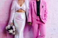 an iridescent bridal separate with a crop top and a mermaid skirt, a veil, a hot pink pantsuit, a black shoes and black shoes