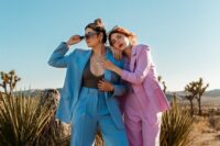 bold bridal looks with a blue pantsuit and a black bodysuit, a pink pantsuit and platform shoes are wow