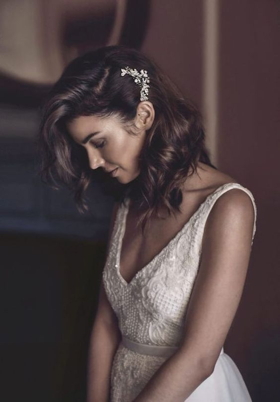 medium hair can be styled in waves, as a side-swept hairstyle with a rhinestone hairpiece, it's great for a chic bride