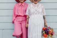 pink flare pants and a boho pink shirt, pink boots and a hat, a boho lace wedding dress with a train and a hat