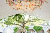 03 large chandelier with pink and peach flowers and ivory and white shades over the dance floor