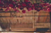 03 red carnations hanging over the reception will add a romantic flavor