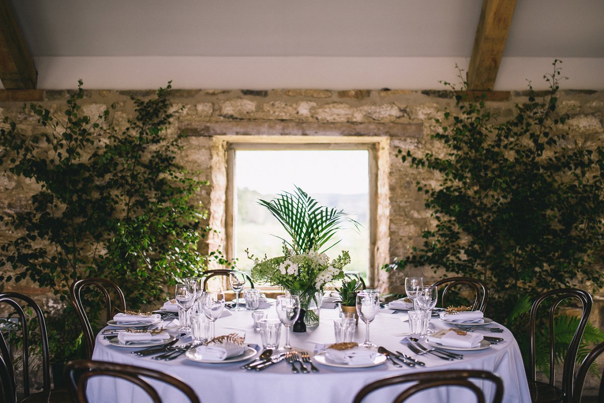 Neutral decor was spruced up with greenery, ferns and white flowers