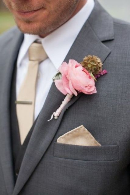 dark grey suit,a beige tie and a pink boutonniere
