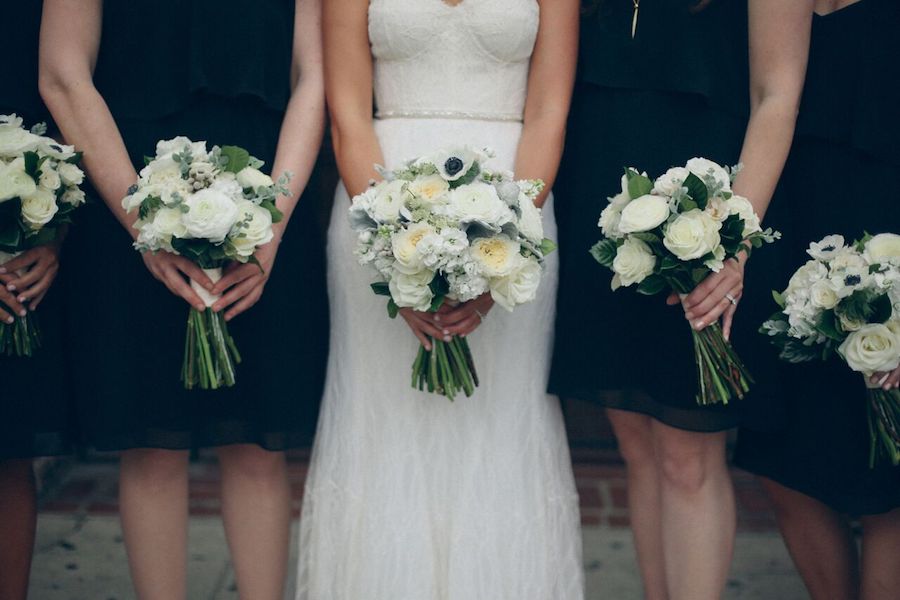 The bridesmaids were dressed in black with white bouquets for a chic look