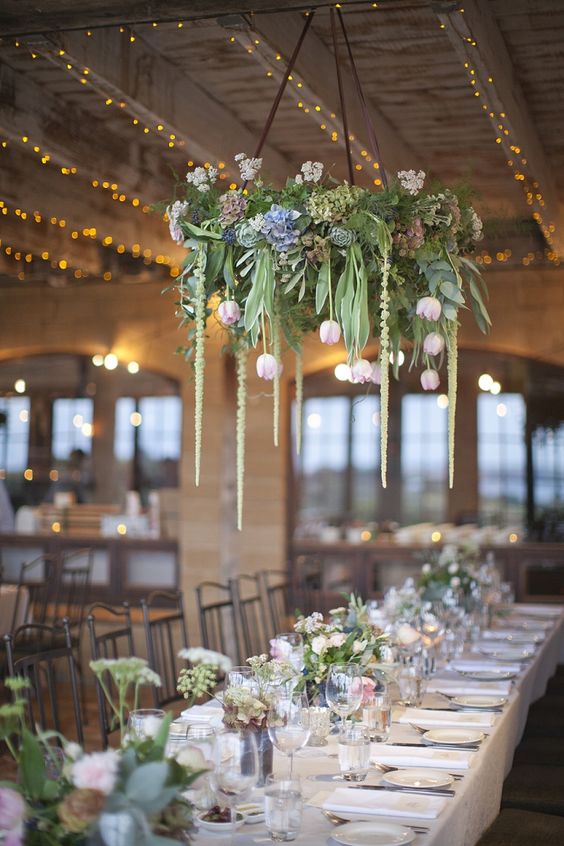 greenery and tulips chandelier hanging over the tables
