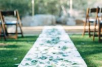 06 white aisle runner decorated with scattered eucalyptus leaves