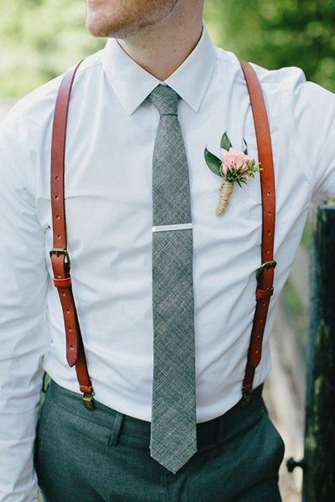 white shirt, a grey tie and brown leather suspenders