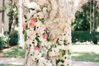 09 a large tree covered with pastel and neutral flowers and crystals