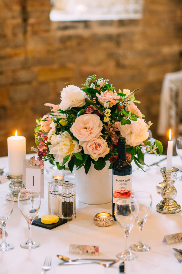The table decor was cute and rustic-inspired, with candles and pink florals