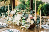 11 beautiful rustic table setting with an uncovered table and a neutral flower centerpiece