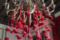 11 flowers cascading from hanging light or chandelier