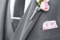 12 grey groom suit with a black tie and a pink boutonniere