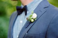 13 blue suit, a grey shirt and a navy bow tie