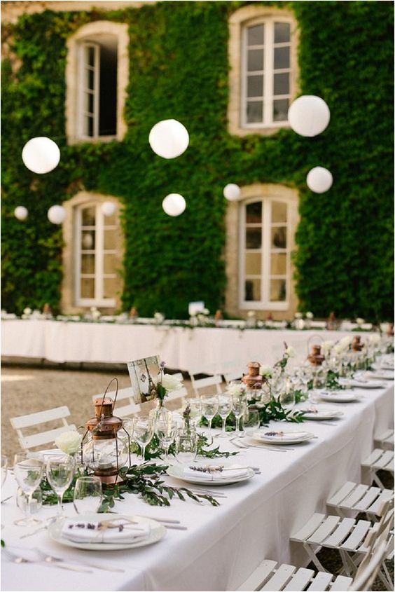 copper lanterns, simple greenery and white table top and chairs