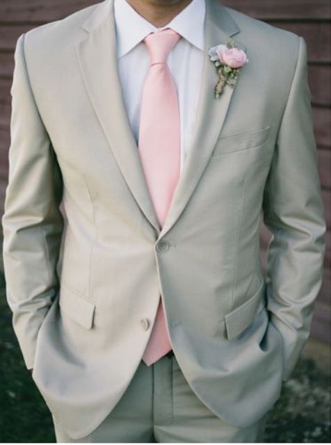 light grey suit with a light pink tie and boutonniere