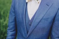 14 blue suit, a vest and a whimsy floral bow tie