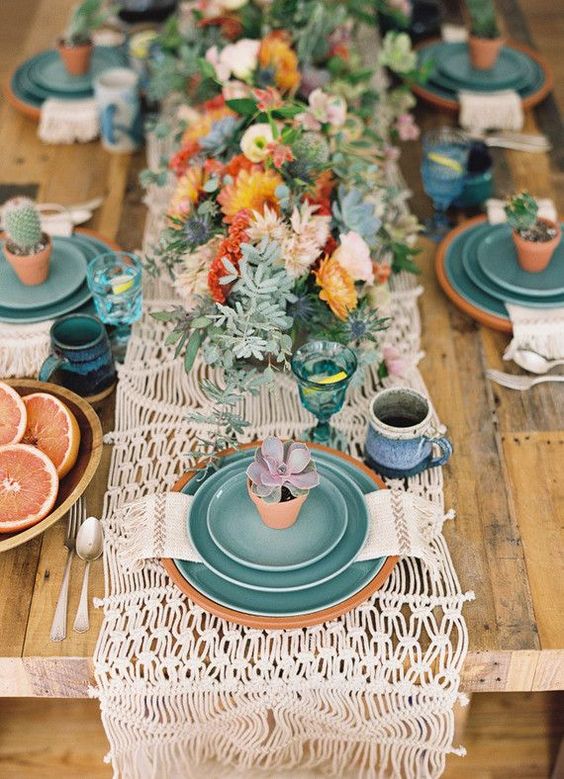 a crochet table runner, bold florals and plates are ideal for a boho tablescape