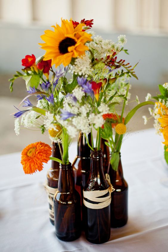 beer bottle vases with wildflowers