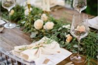 16 rustic wood table with a greenery and flower swag runner