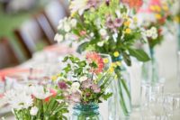 17 blue jars with pastel wildflowers to line the tables