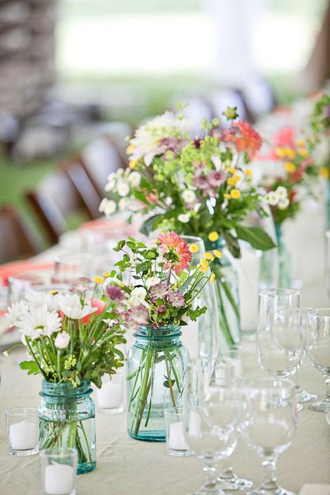 blue jars with pastel wildflowers to line the tables