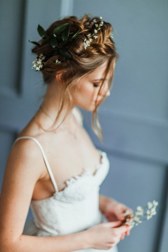 braided updo with fresh greenery and flowers