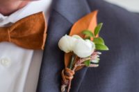 18 dark grey suit, a copper bow tie and a copper and white boutonniere