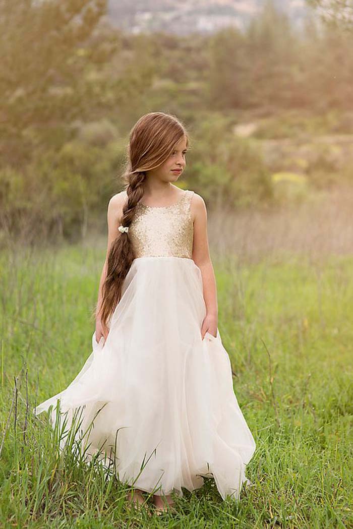 a gold sequin bodice and a flowy ivory skirt