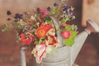 23 wildflowers in a watering can as a decoration or centerpiece