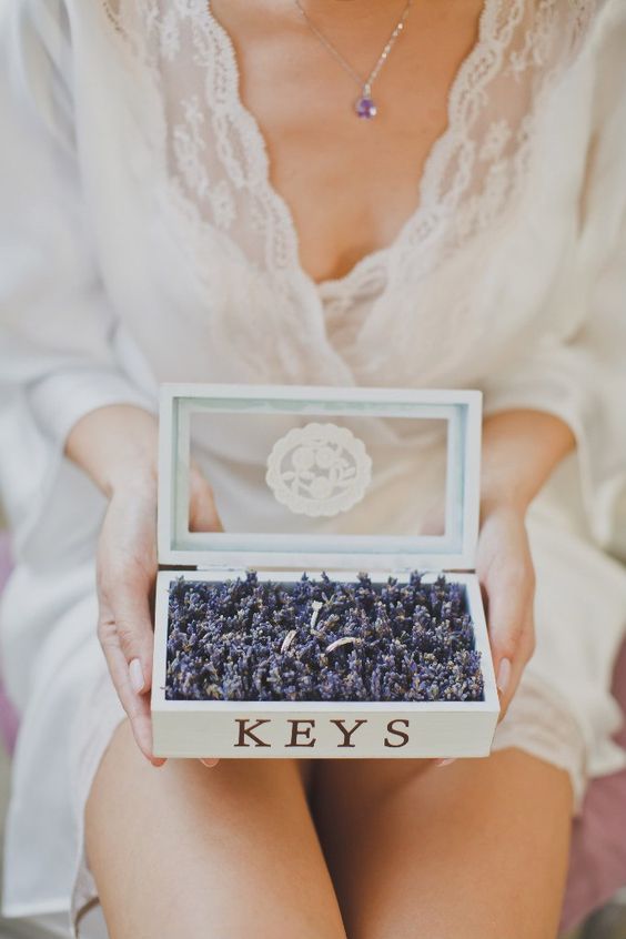 creative way to display the wedding bands, in a box filled with lavender
