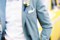 25 light blue suit with a white shirt and a whimsy-patterned bow tie