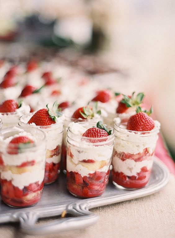 mason jars with strawberries and whipped cream
