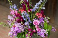 25 purple, pink and blue wildflowers in a bucket