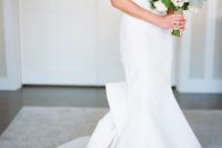 25 sleek wedding dress with a mermaid silhouette and a bow on the back