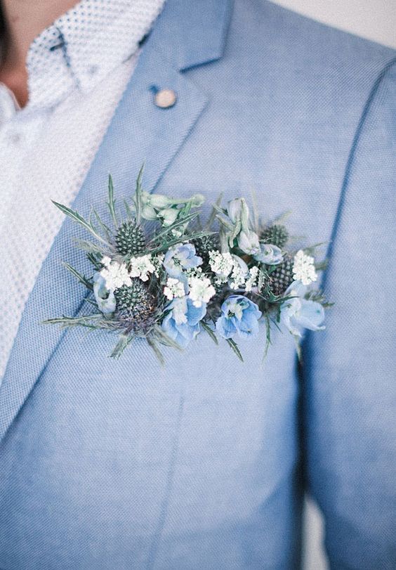light blue suit, a patterned shirt and a lush blue flower and thistle boutonniere
