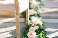 27 blush roses and greenery garland that goes along the aisle