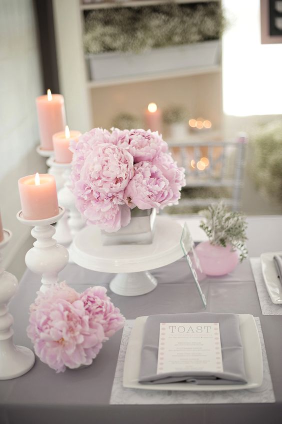 grey fabrics and pink florals and candles for the table decor